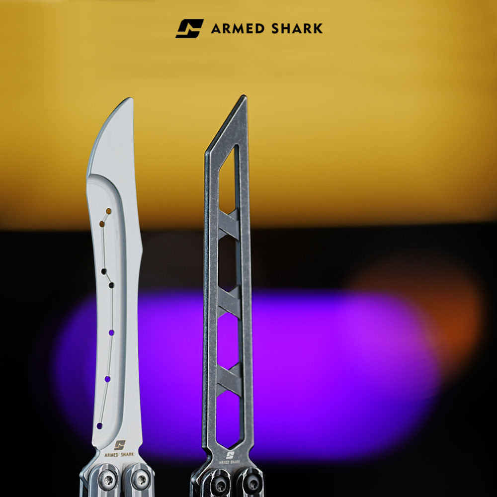 Close-up of Armed Shark Prism Balisong Trainer showing unsharpened edge and CNC hollow handle design