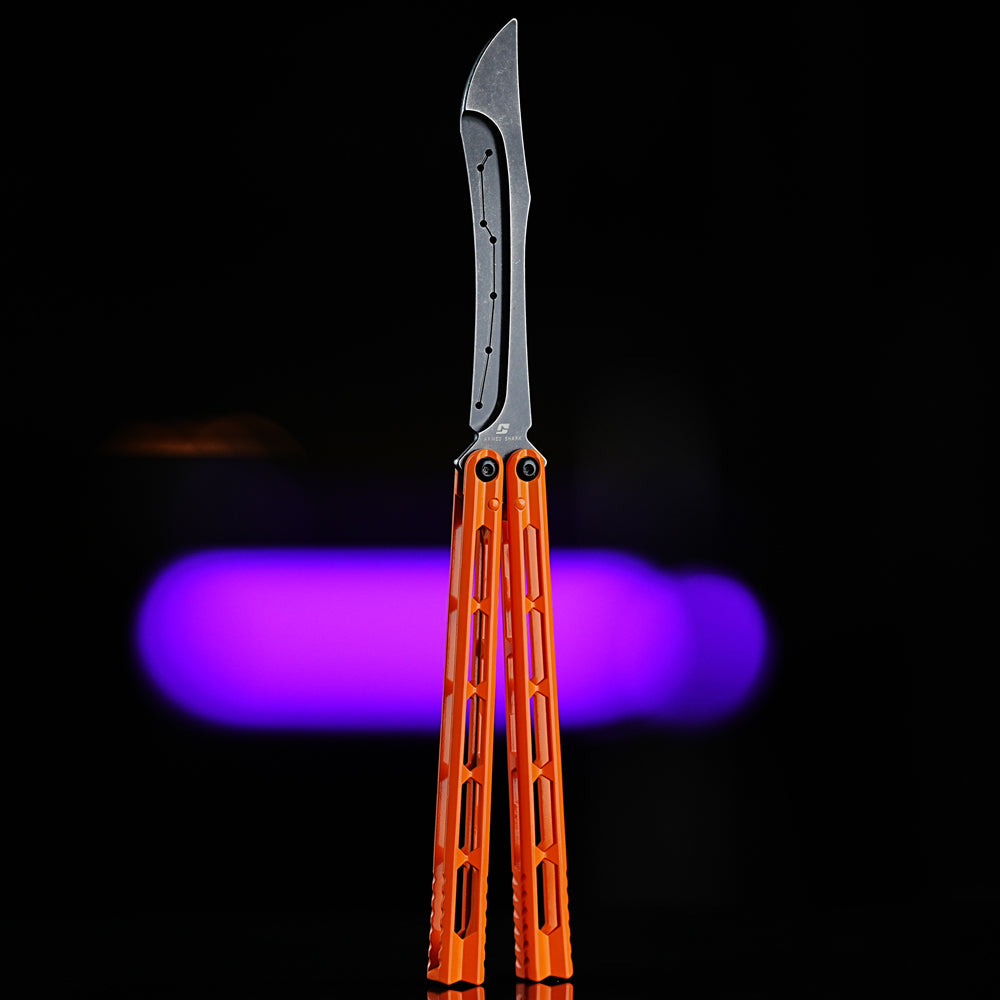 Armed Shark Prism Balisong Trainer in orange color front view showing full handle structure and stone-washed training edge