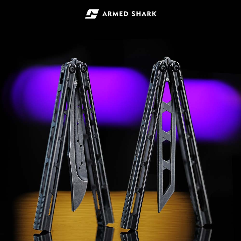 Armed Shark Prism Balisong Trainer standing display showing folded handles and unsharpened training edge