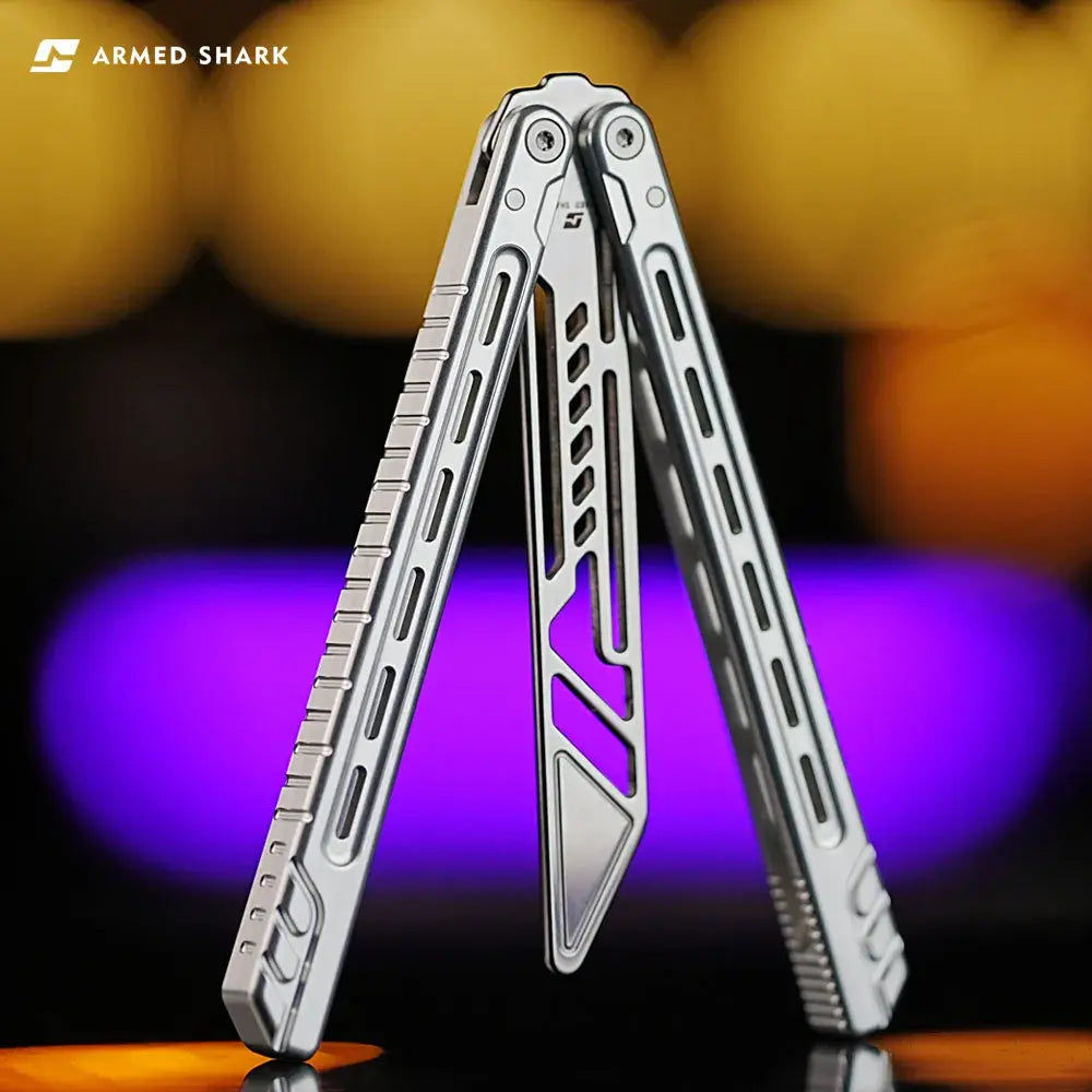 Armed Shark Athena Balisong Trainer in silver finish, half-open position showing CNC-machined handles and precision cutouts under studio lighting