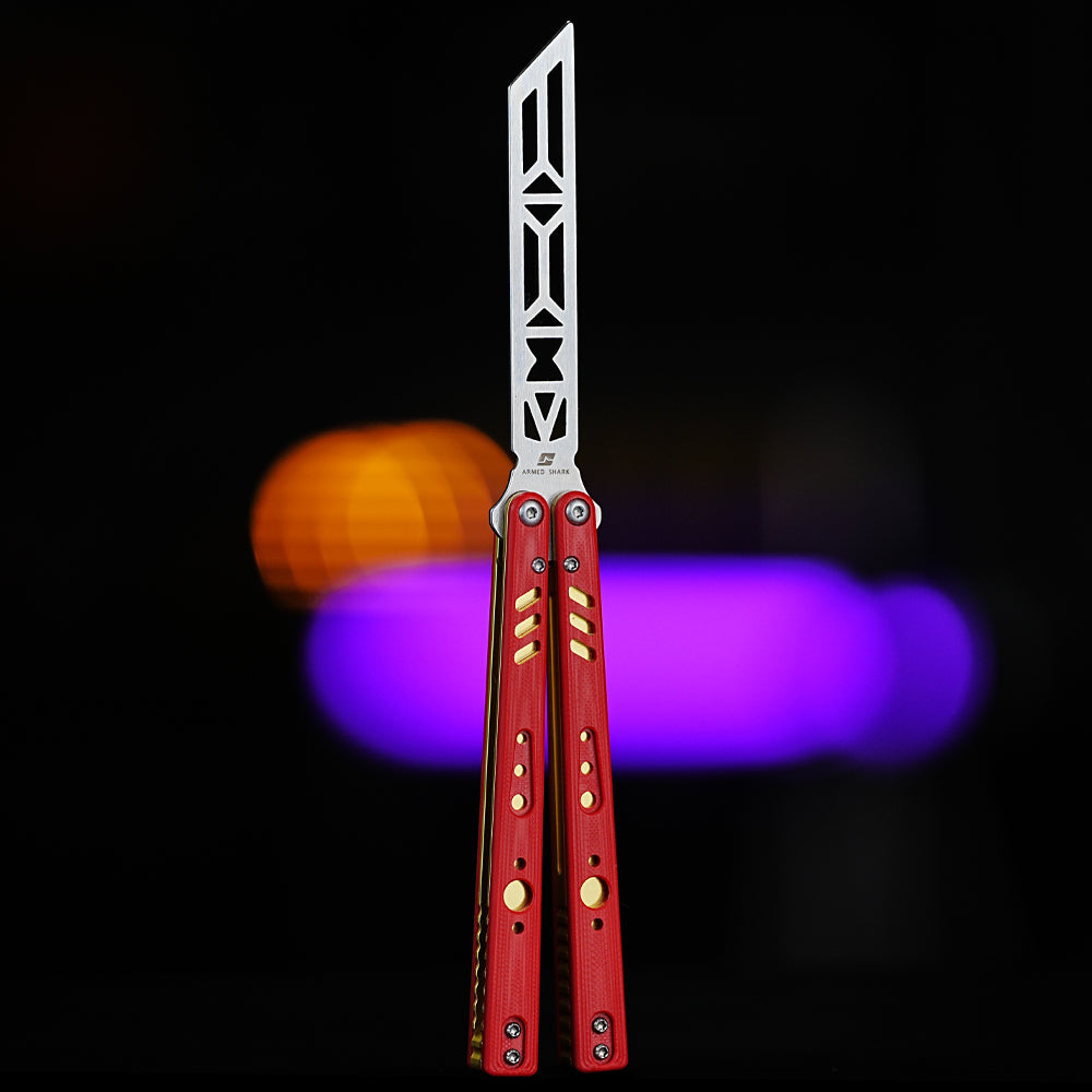 Armed Shark REP Balisong Trainer Knife V2 with red handle and gold accent liners – unsharpened stainless steel blade trainer.