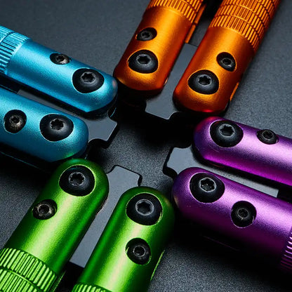 Close-up of Armed Shark Sahara Butterfly Trainer handles in green, orange, blue, and purple aluminum finishes