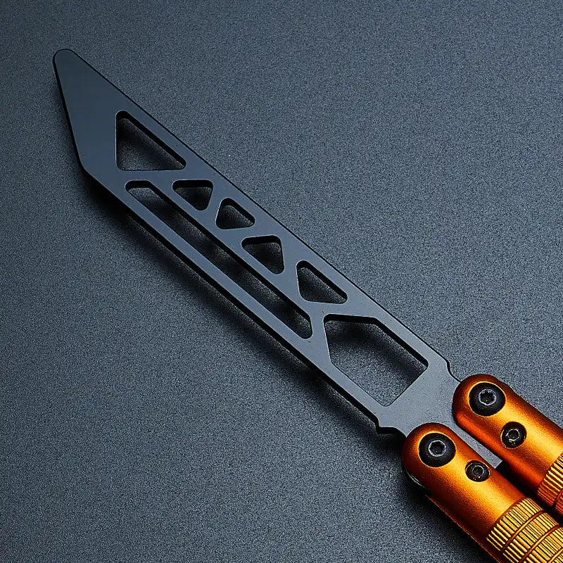 Close-up view of Armed Shark Sahara Butterfly Trainer with orange aluminum handle and black training edge