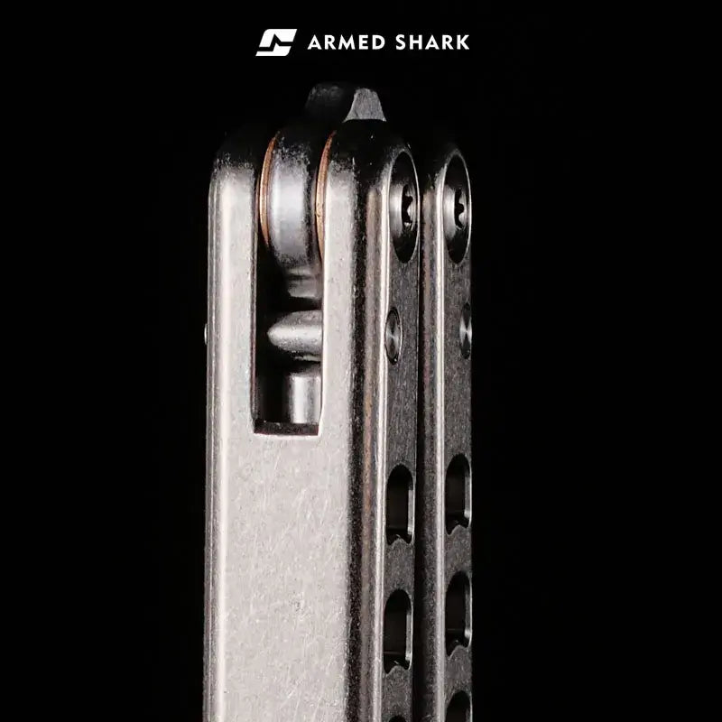 Close-up view of the Armed Shark Titanium Inked Mako Bottle Opener Trainer showing the precision pivot system and titanium handle construction